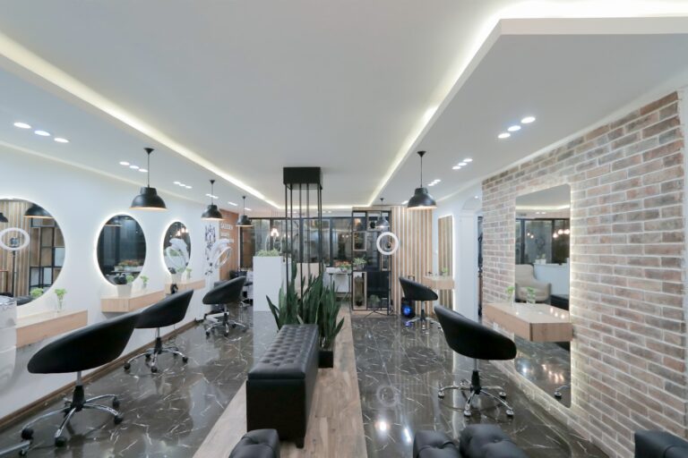 Modern styling area with lit mirrors at DM Salon, Hooghly